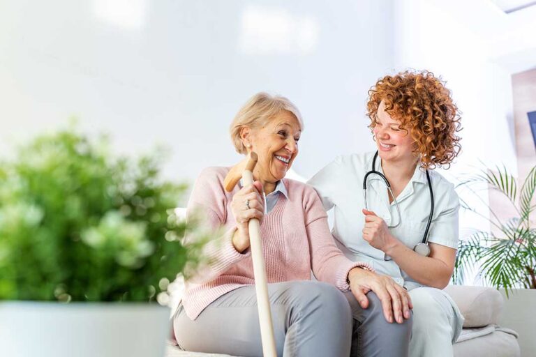 Older adult and family caregiver reviewing belongings in a welcoming assisted living room.